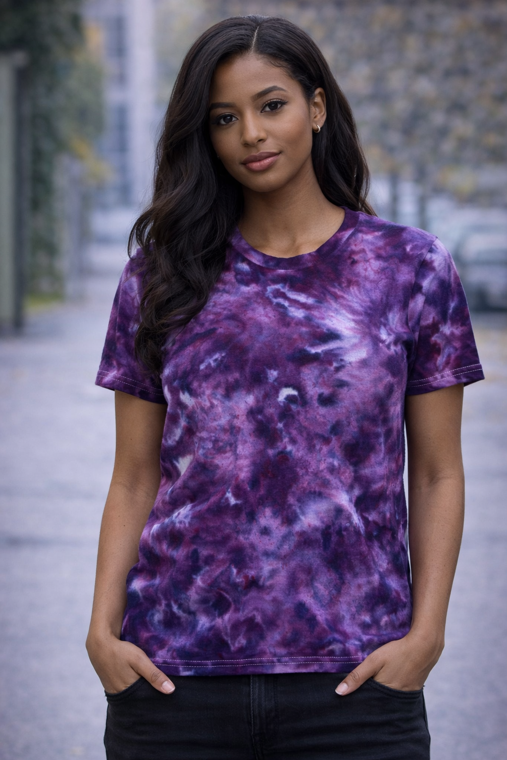Woman wearing a purple tie-dye t-shirt with a blurred outdoor background