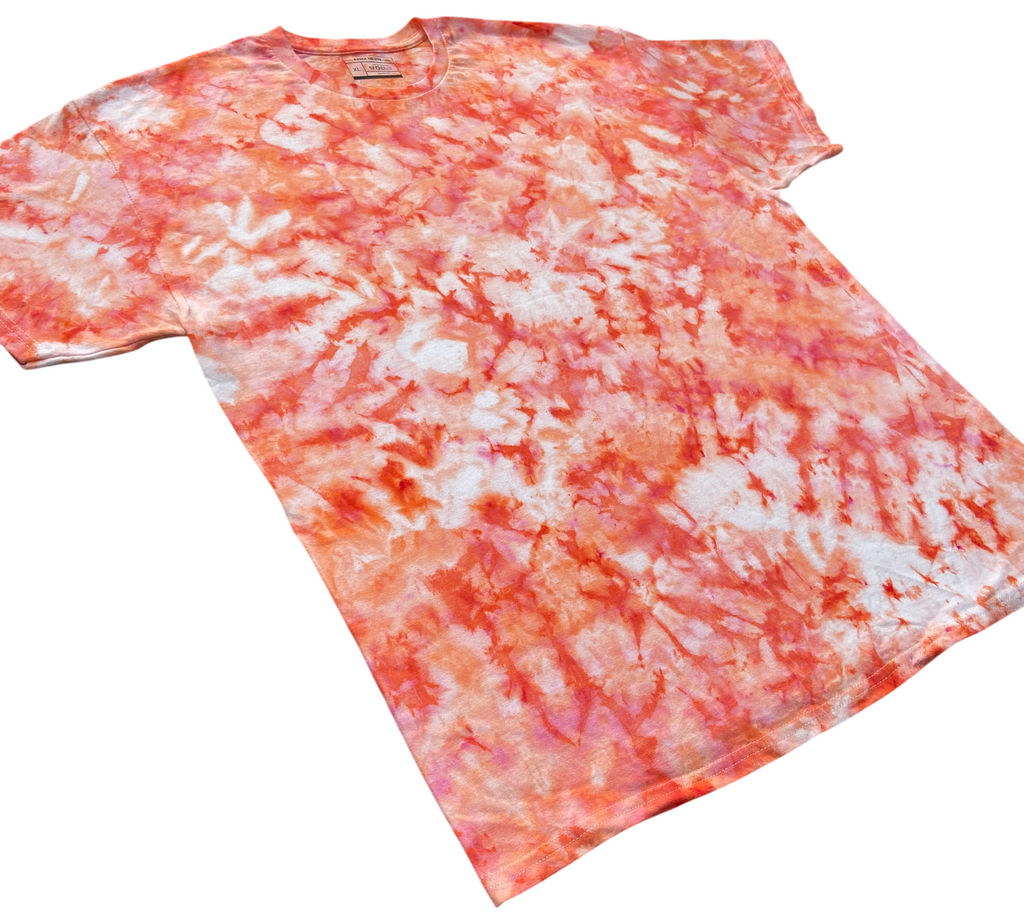 A short-sleeve crewneck t-shirt featuring a vibrant orange and white tie-dye pattern, laid flat against a solid white background.