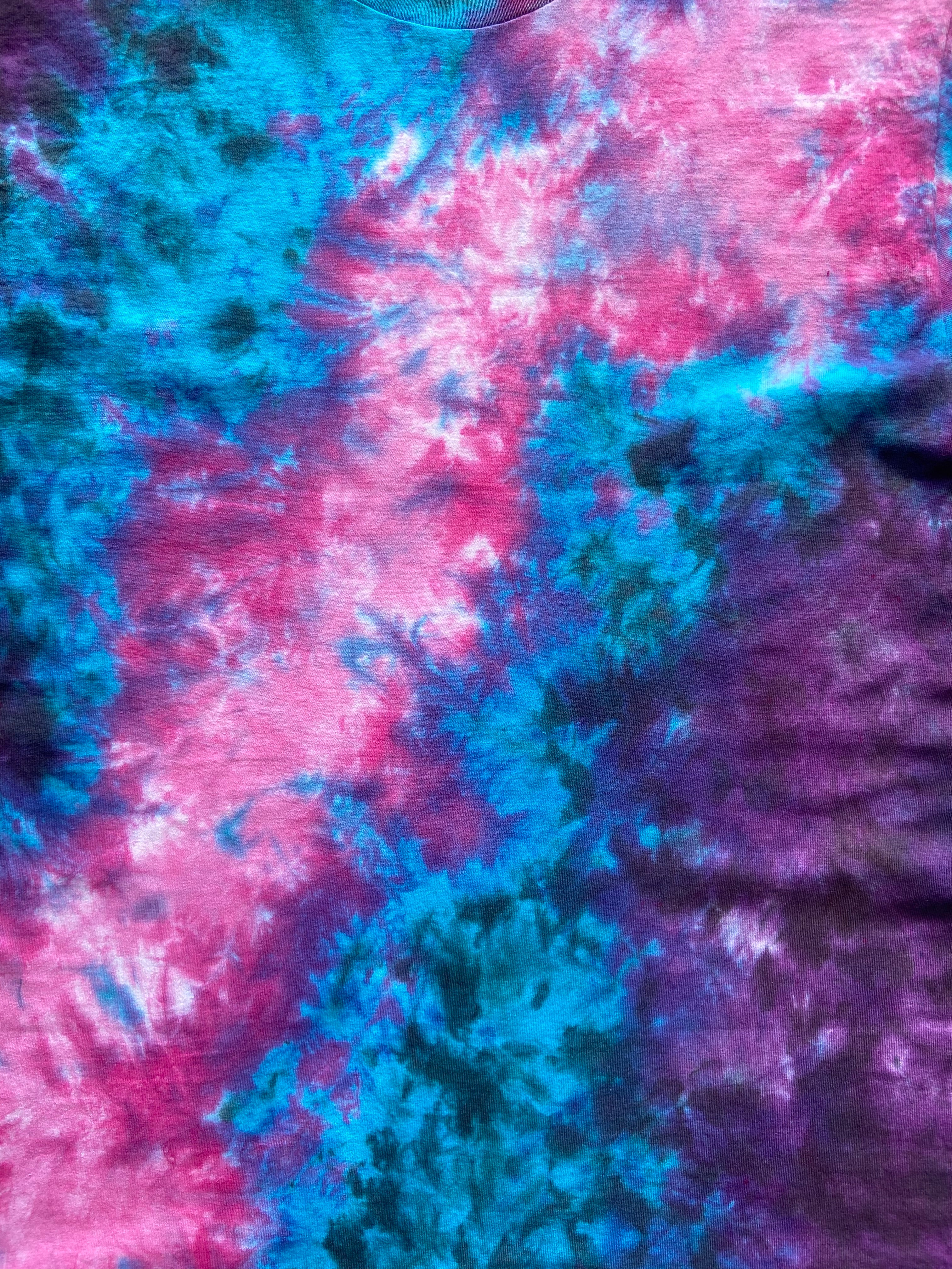 Close-up of tie-dye fabric with pink and blue patterns