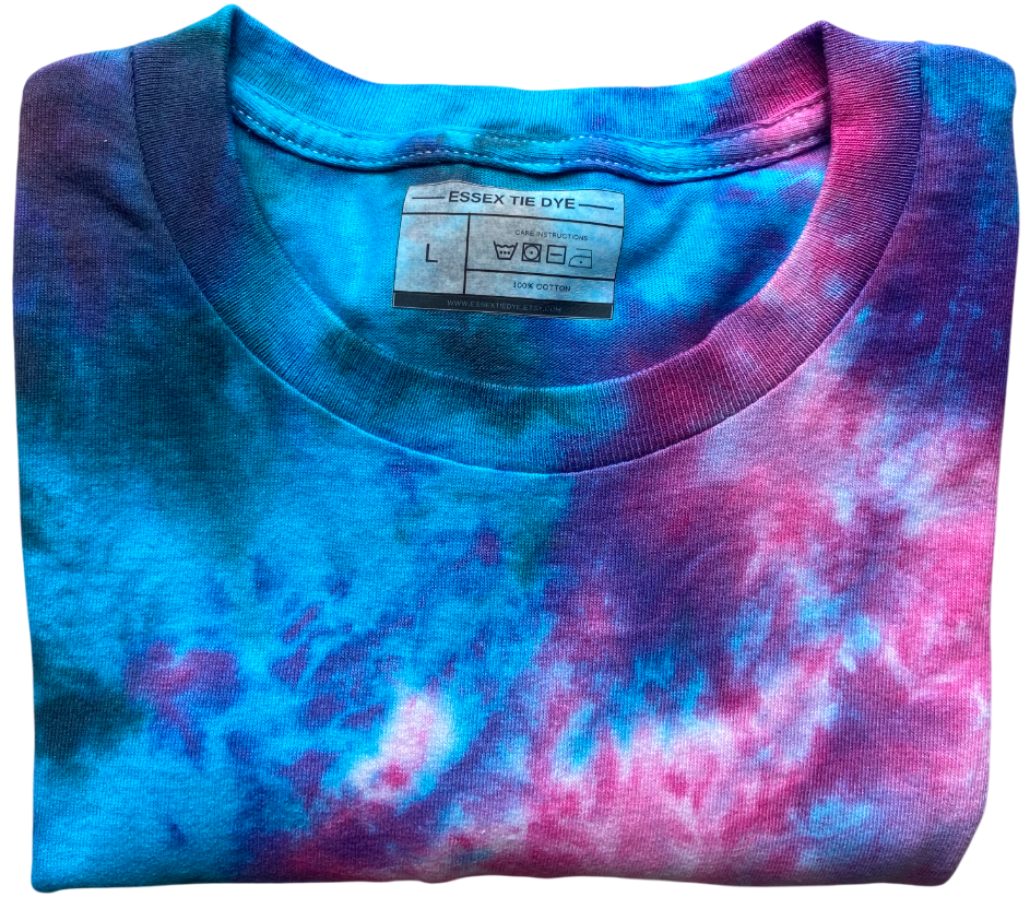 Folded tie-dye shirt with blue and pink colors and Essex Tie Dye label.