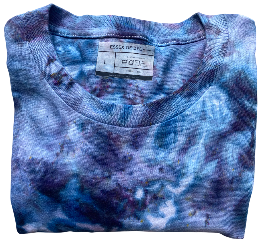 Folded blue and purple tie-dye shirt with a label on a white background
