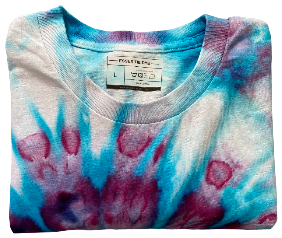 Folded tie-dye shirt with a visible label on a white background