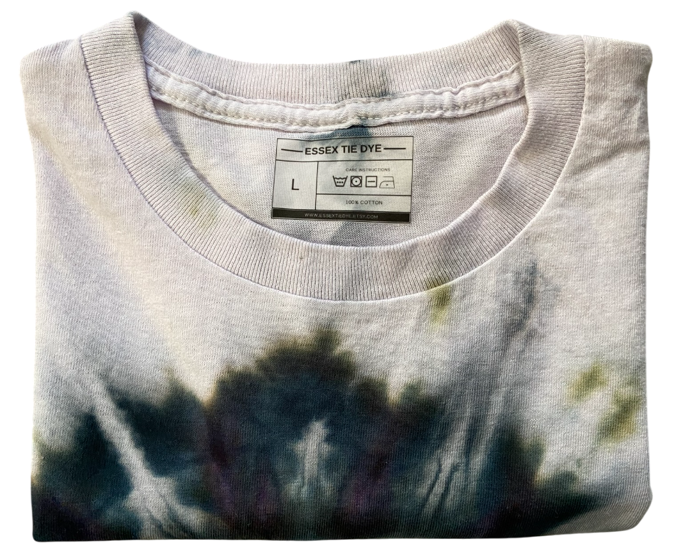 Folded tie-dye shirt with a visible label on a white background