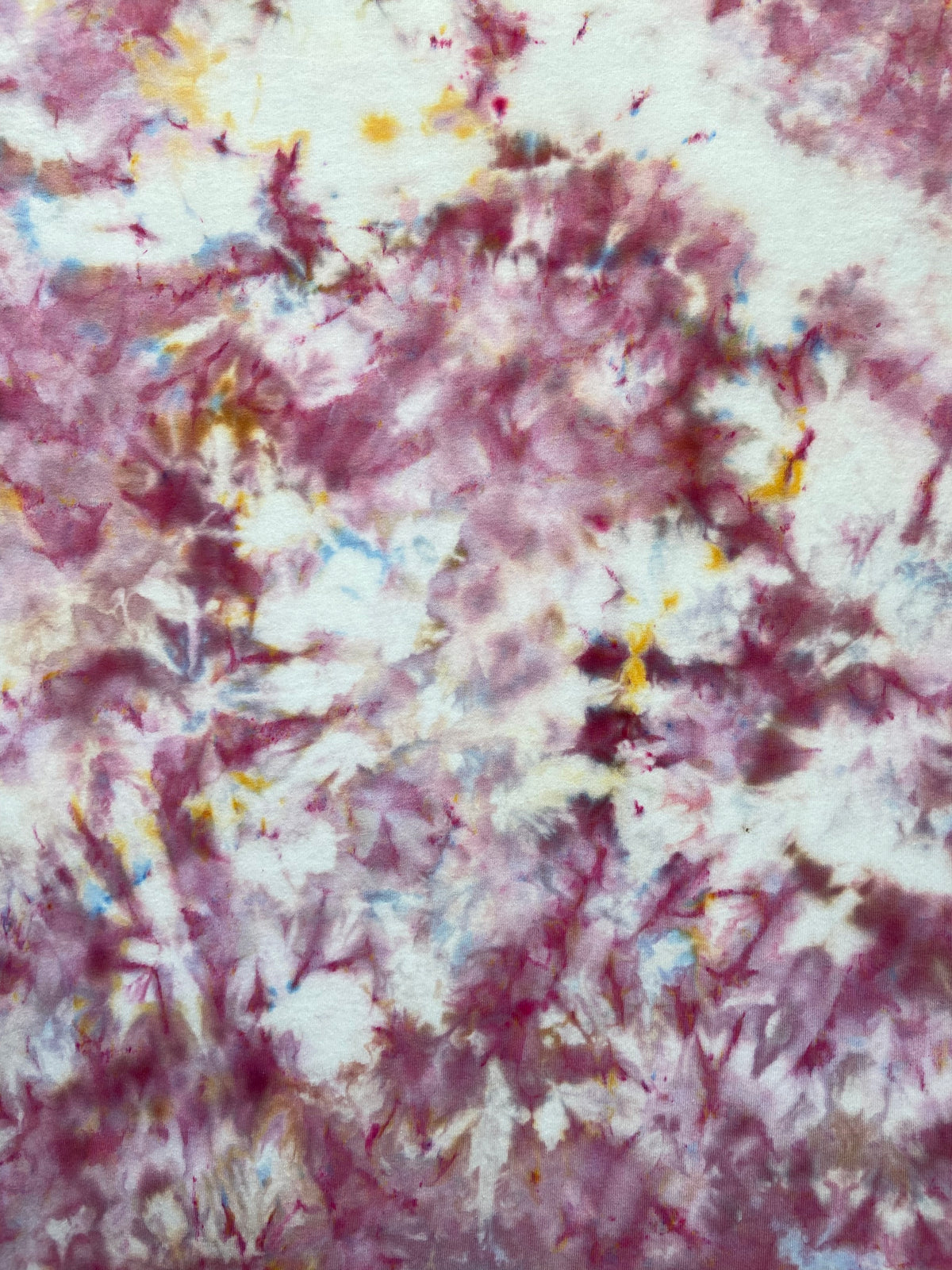 Close-up of the Powder Pink Ice Scrunch tie dye pattern in soft pink, dusty rose and white with subtle blue and yellow accents, showing the hand dyed fabric detail.