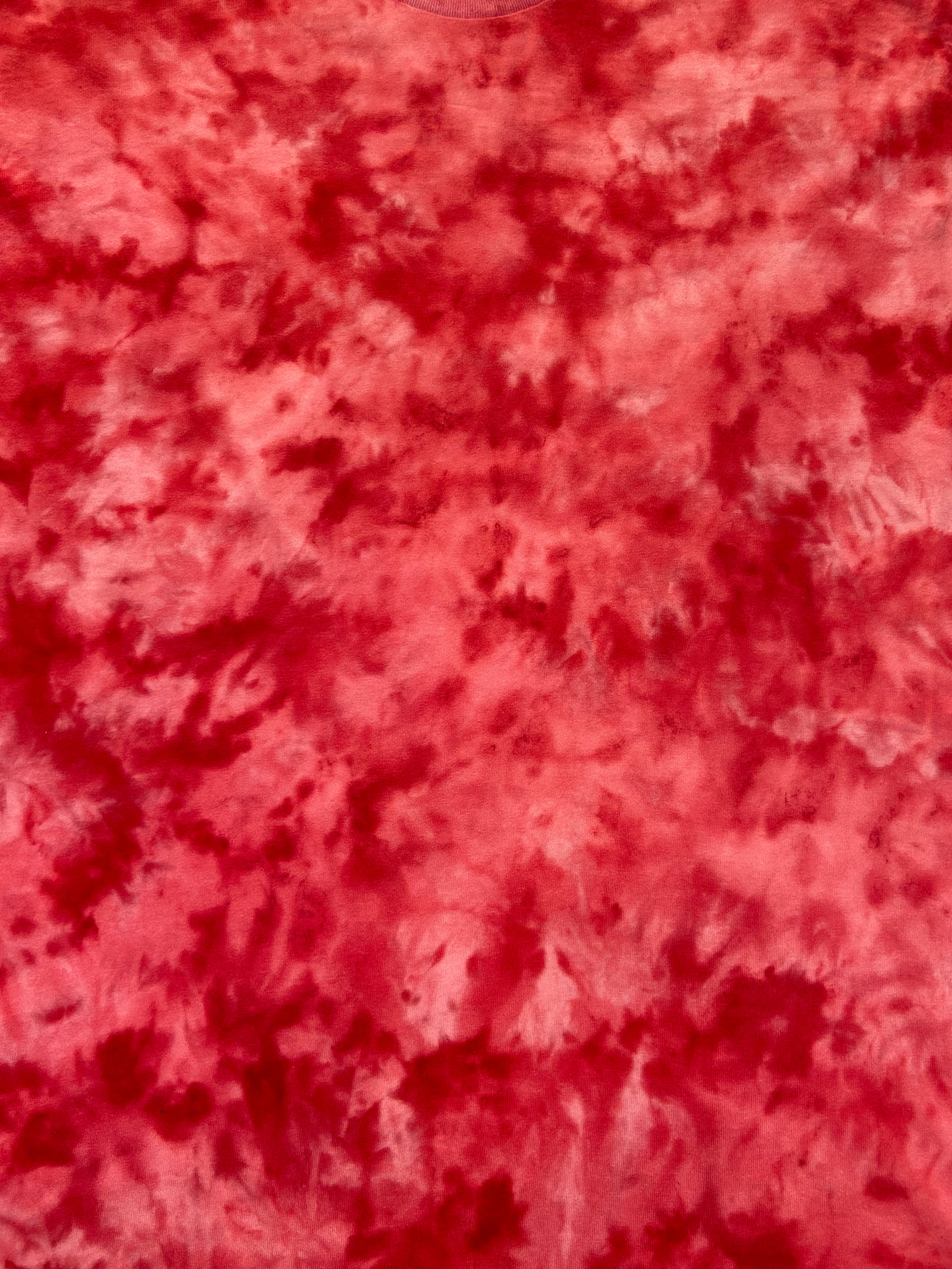 Close-up of the Atomic Fireball Ice Scrunch tie dye pattern in fiery red, coral and orange tones, showing the hand dyed fabric detail.