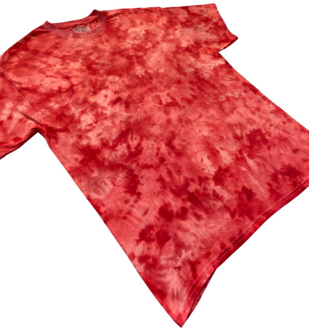 Angled view of the Atomic Fireball Ice Scrunch tie dye T-shirt in fiery red, coral and orange tones, showing the hand dyed scrunch pattern on a white background.