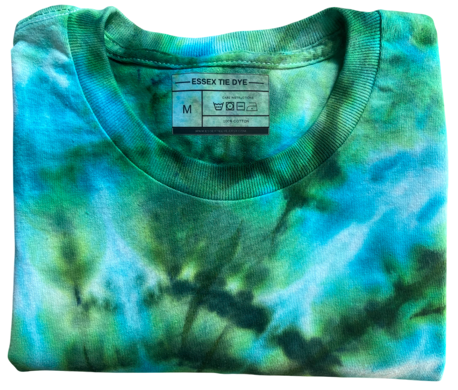 Folded tie-dye shirt with a visible brand label on a white background