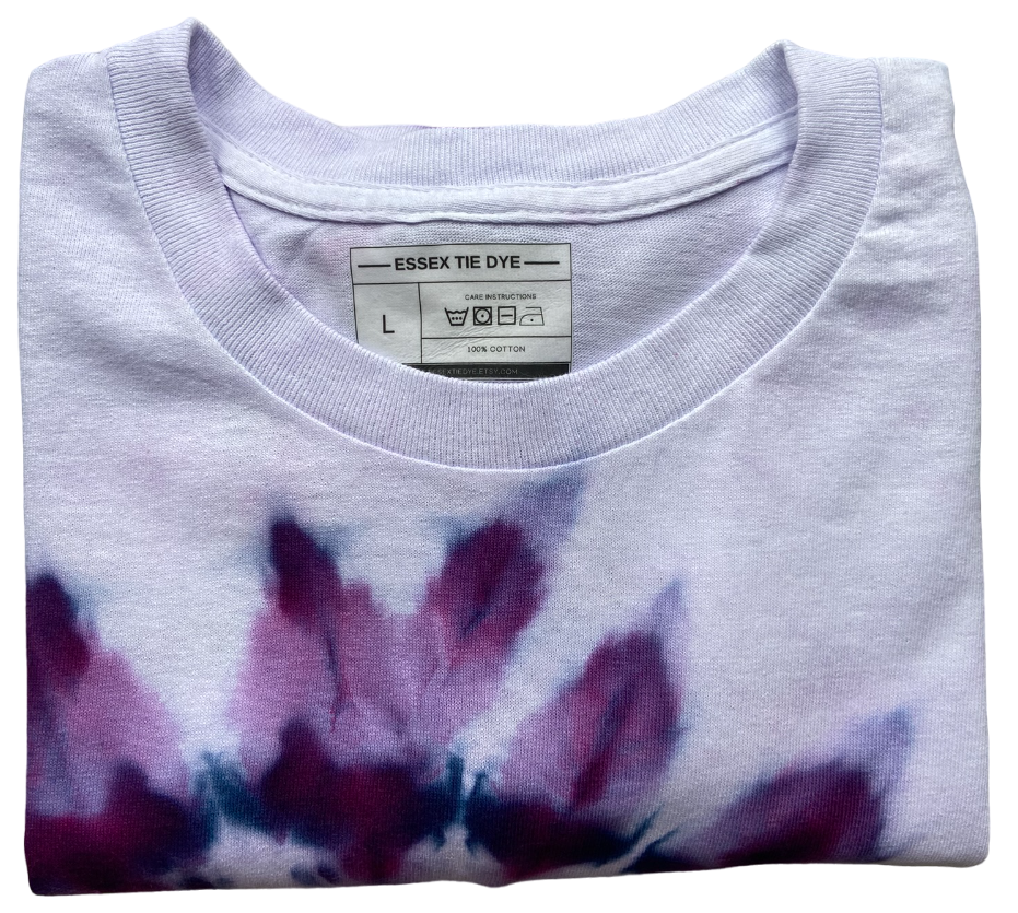 Folded tie-dye shirt with a visible label on a white background