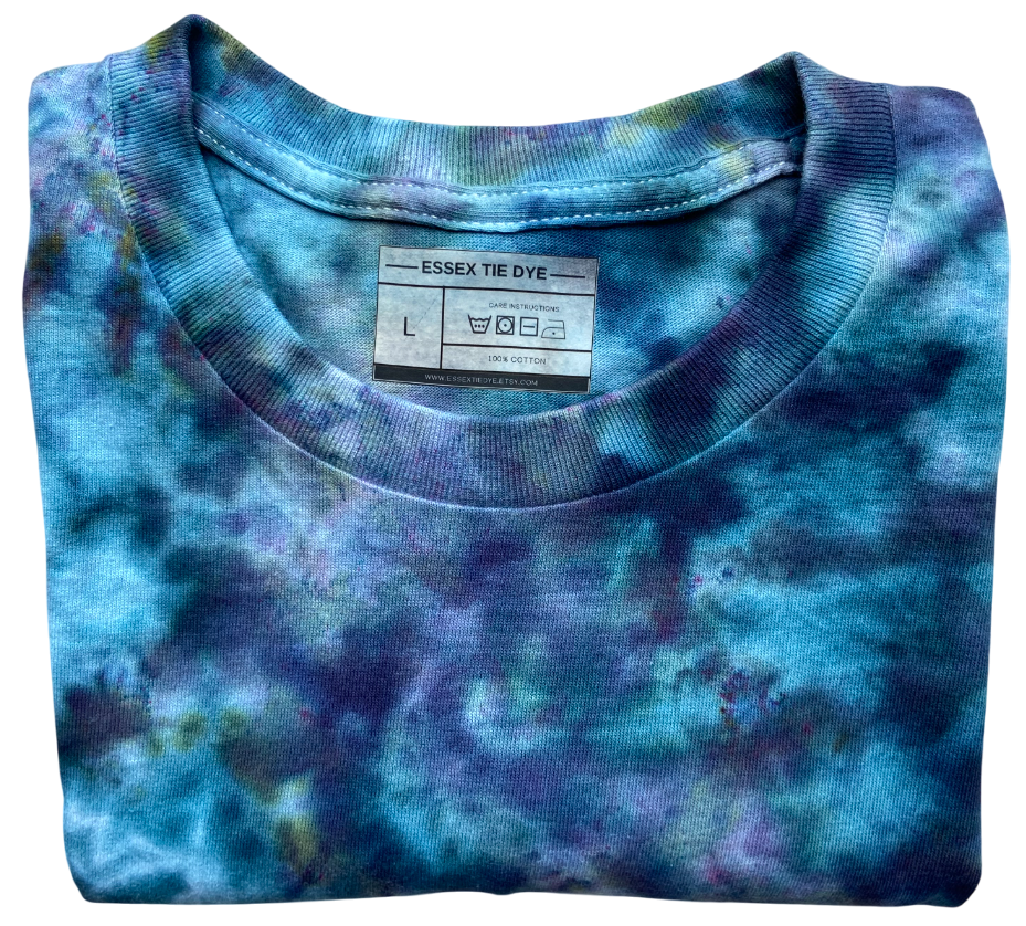 Folded blue tie-dye shirt with a visible label on a white background
