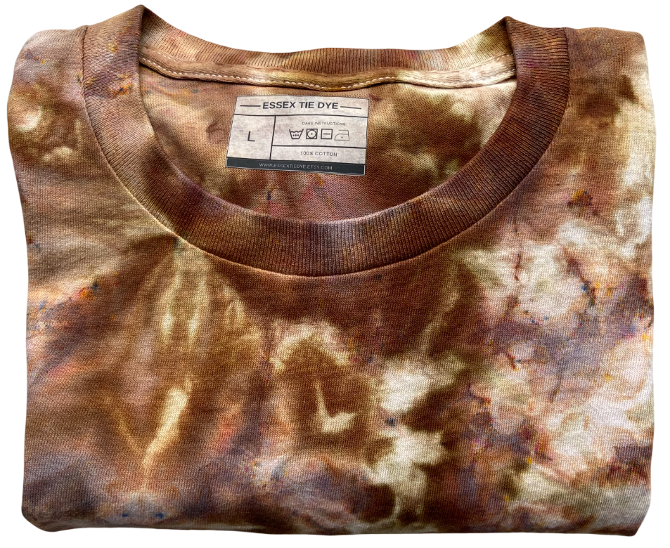 Folded tie-dye shirt with a visible label on a white background