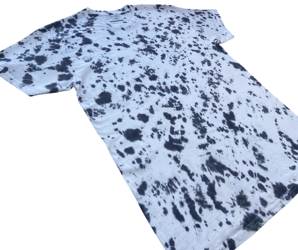 Better Black Scrunch tie-dye T-shirt shown at an angle, featuring a bold black splatter scrunch pattern on a white background.