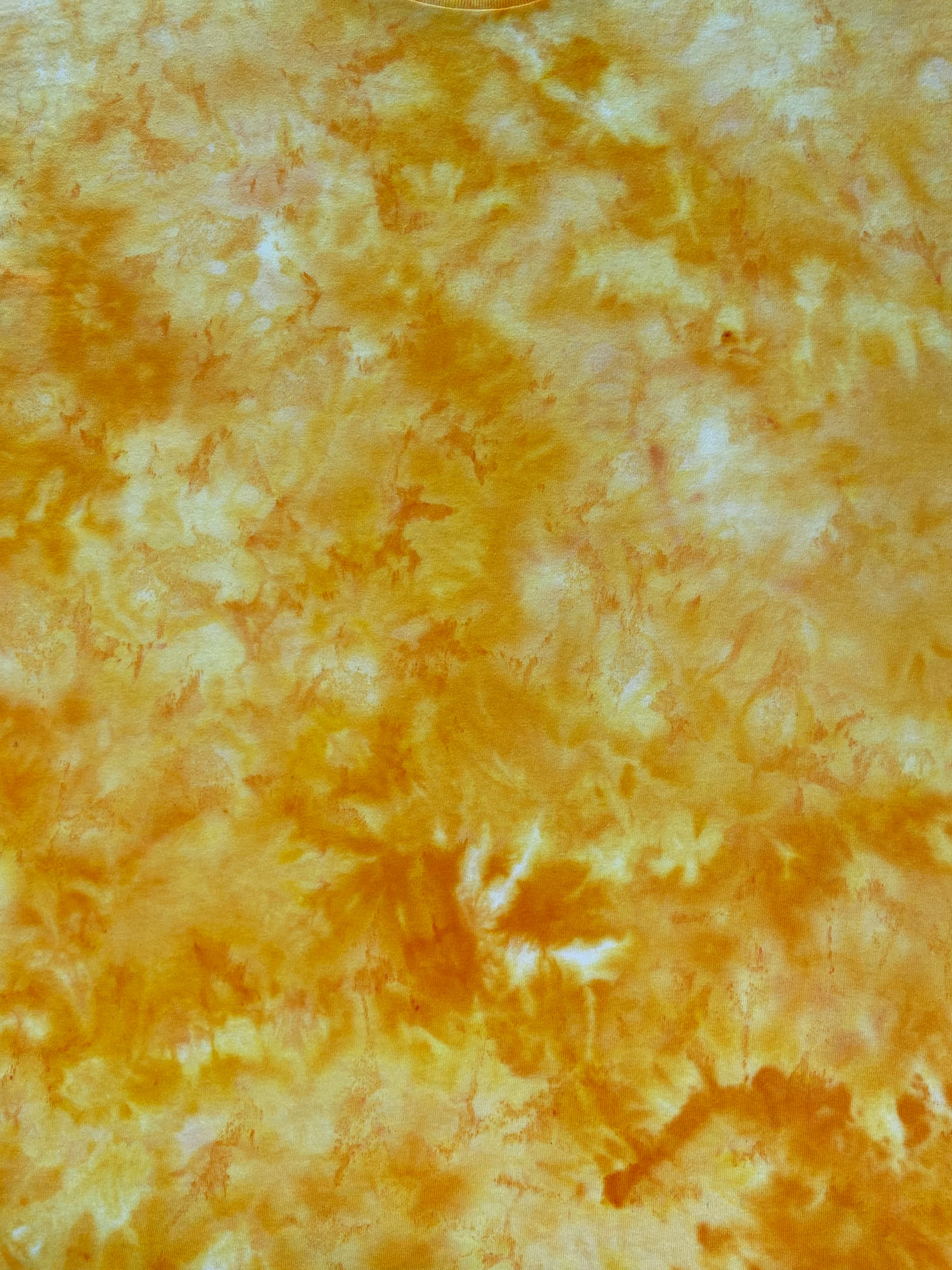 Close-up of Clear Yellow Ice Scrunch tie-dye fabric featuring clear yellow, golden yellow and soft cream marbled patterns.