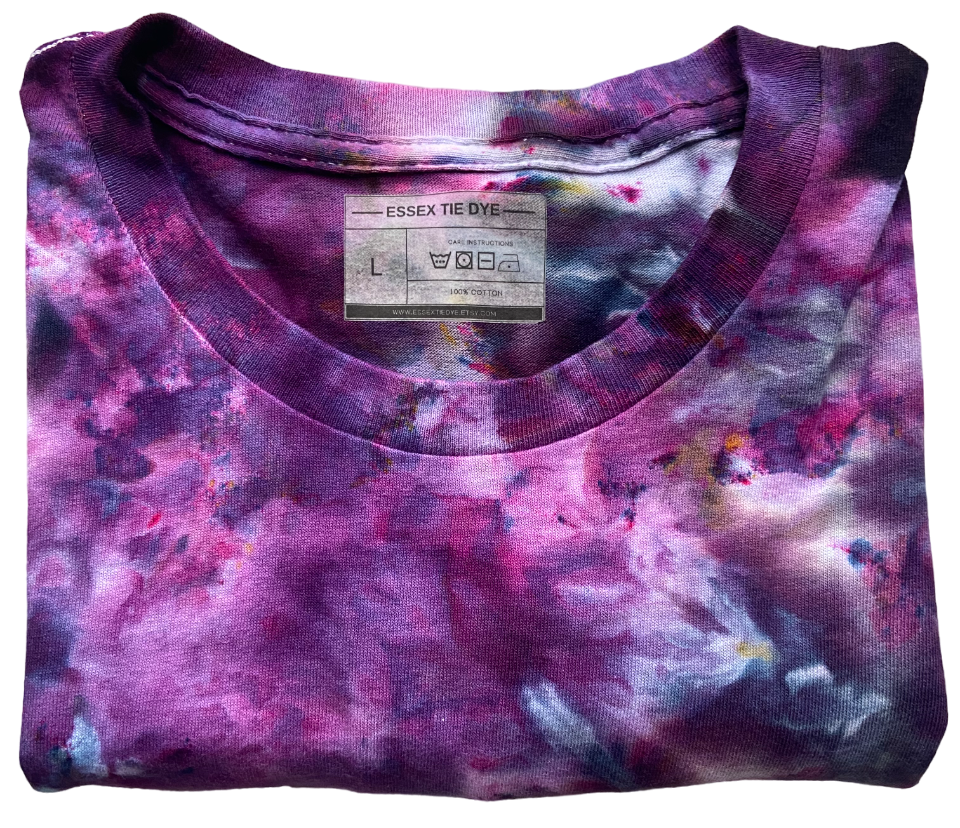 Folded tie-dye shirt with a visible brand label on a white background