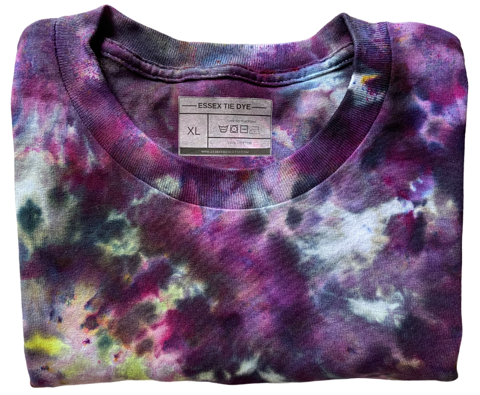 Folded tie-dye shirt with a label on a white background