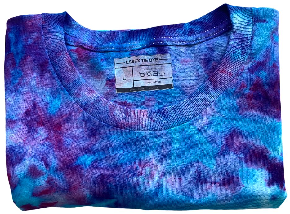 Folded tie-dye shirt with a visible label on a white background