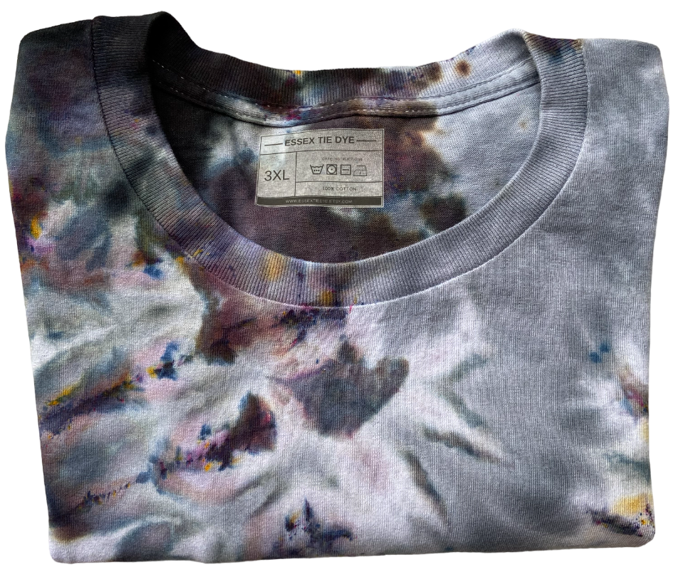 Folded tie-dye shirt with a label on a white background