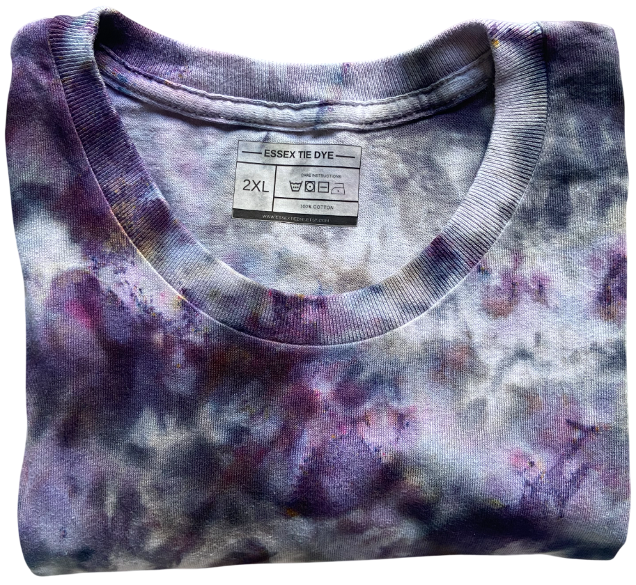 Folded tie-dye shirt with a visible label on a white background