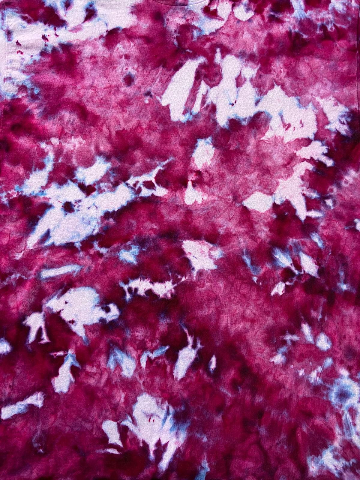Close-up of Amethyst Ice Scrunch tie-dye fabric showing deep burgundy, magenta, purple and pale lilac marbled details.