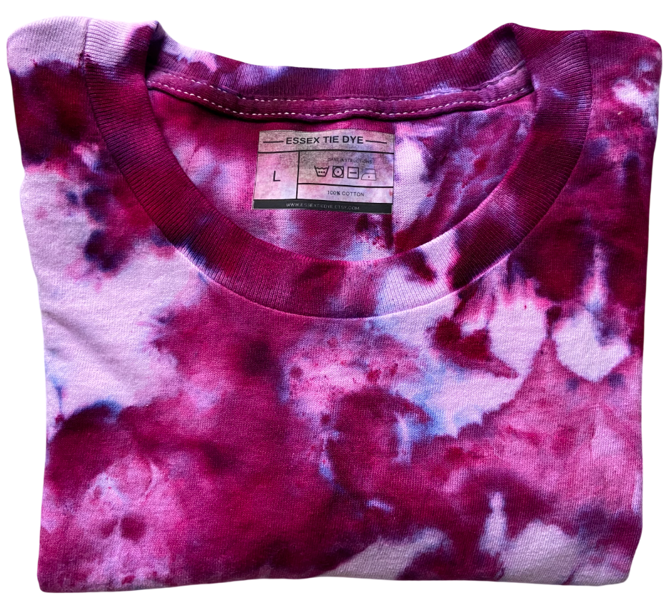 Pink and purple tie-dye shirt with a visible brand label on a white background