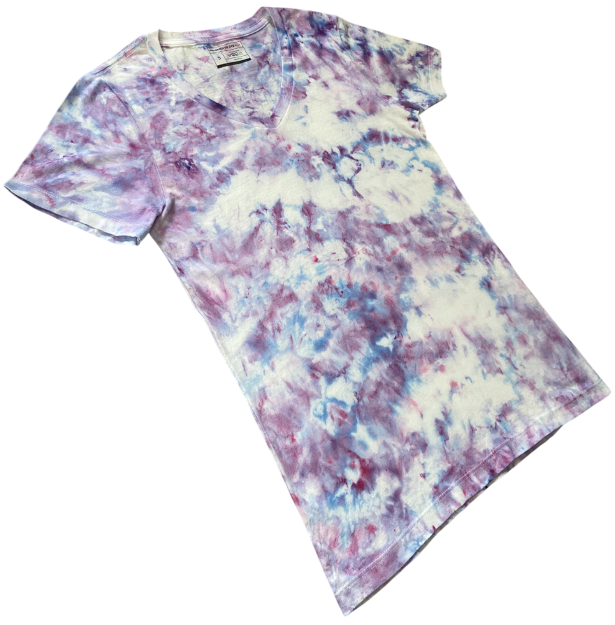 Wisteria tie-dye V-neck T-shirt shown at an angle, featuring soft white, lilac, lavender and pale blue tones.
