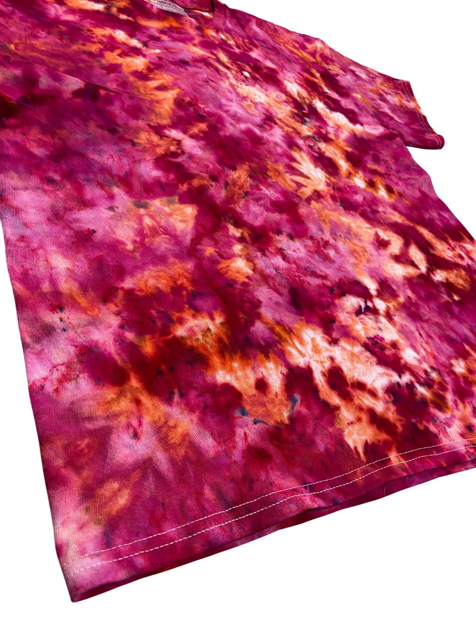 Pink and orange tie-dye fabric on a white background