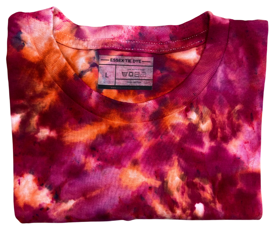 Folded tie-dye shirt with a visible brand label on a white background