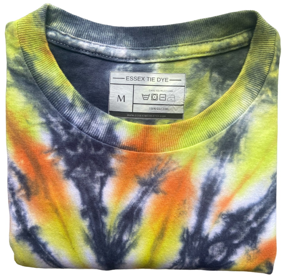 Close-up of the Sunset Vortex tie dye T-shirt neckline showing black, yellow and orange hand dyed fabric and Essex Tie Dye label.