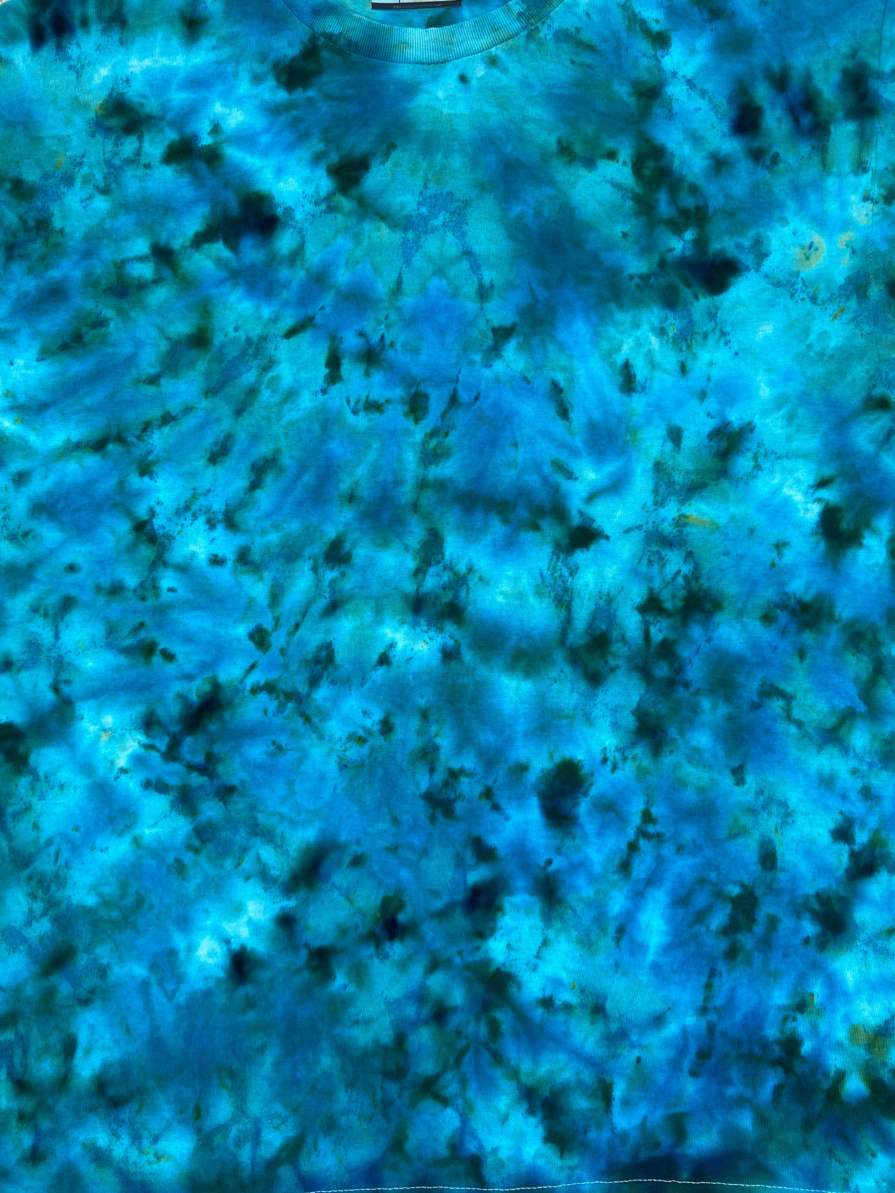 Close-up of blue and green marbled Tie Dye Tshirt