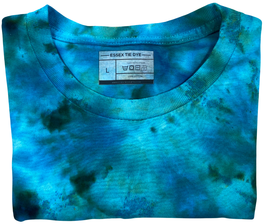 Folded blue tie-dye shirt with a label on a white background