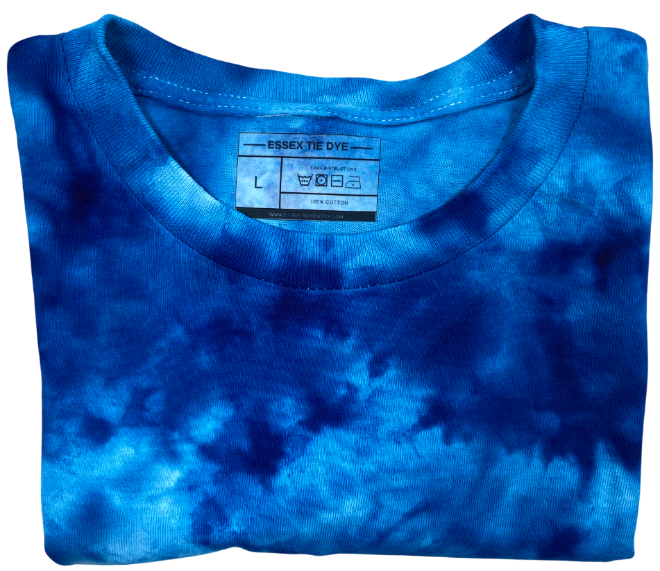 Folded blue tie-dye t-shirt with a label on a white background