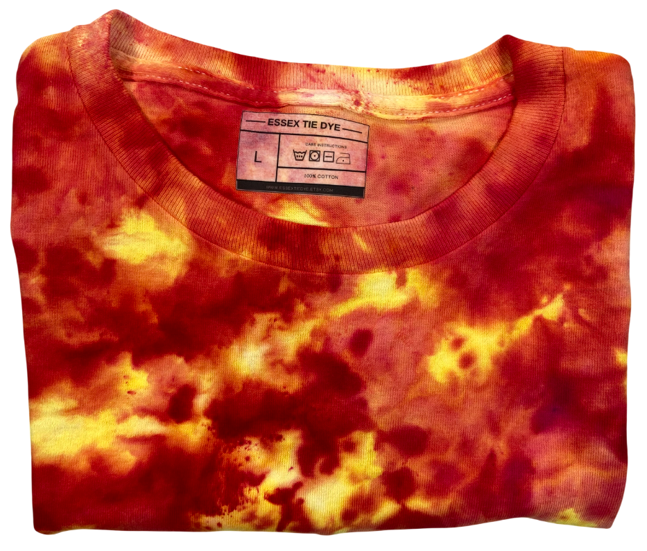 Folded tie-dye shirt with a visible label on a white background