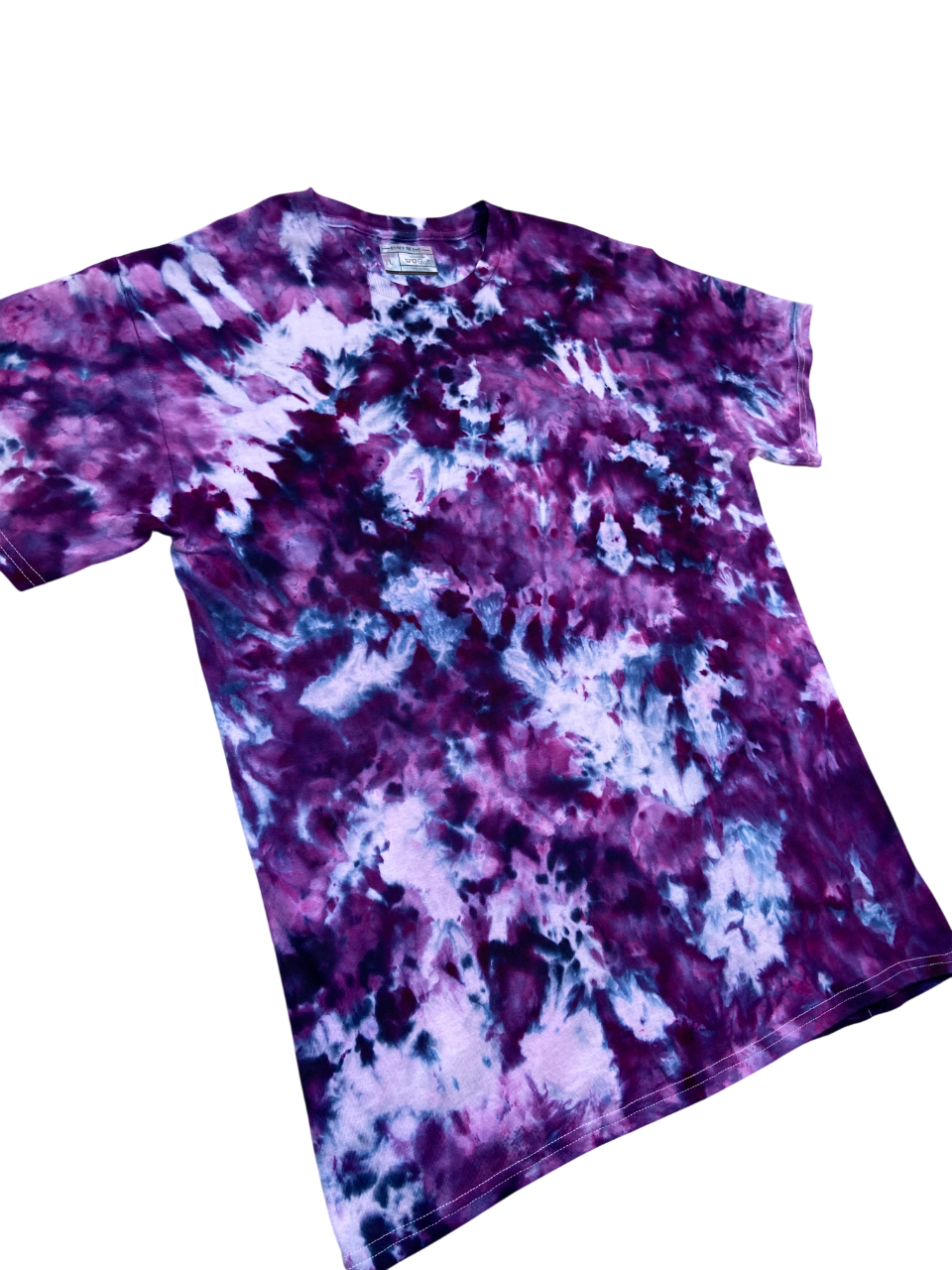 A short-sleeve crewneck tie-dye t-shirt featuring a marbled pattern of purple, violet, and white, laid flat against a solid white background.