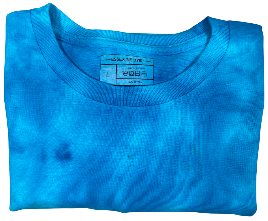 Folded blue t-shirt with a label on a white background