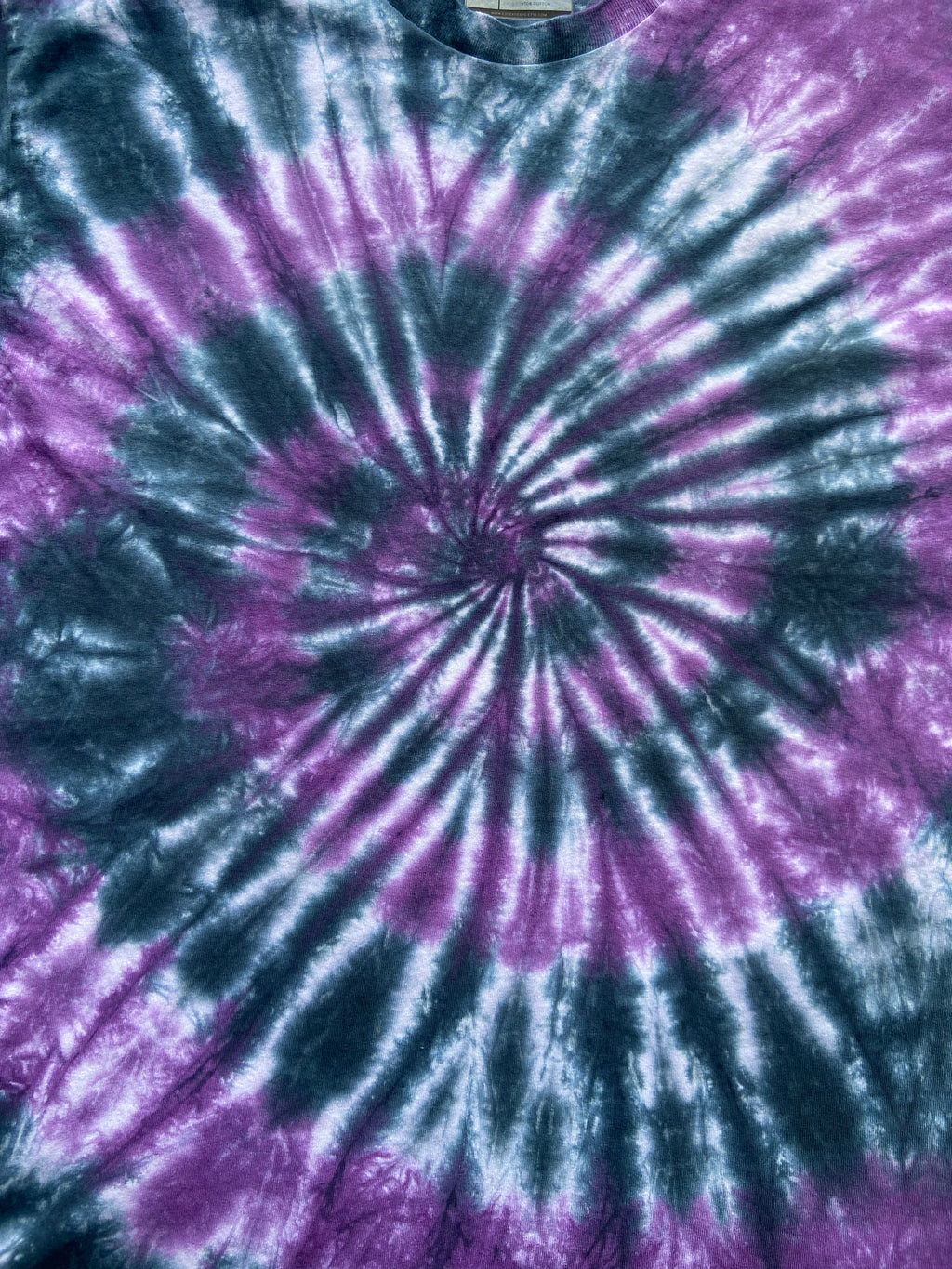 Close-up of the Beetle Spiral tie dye pattern in purple, black and white