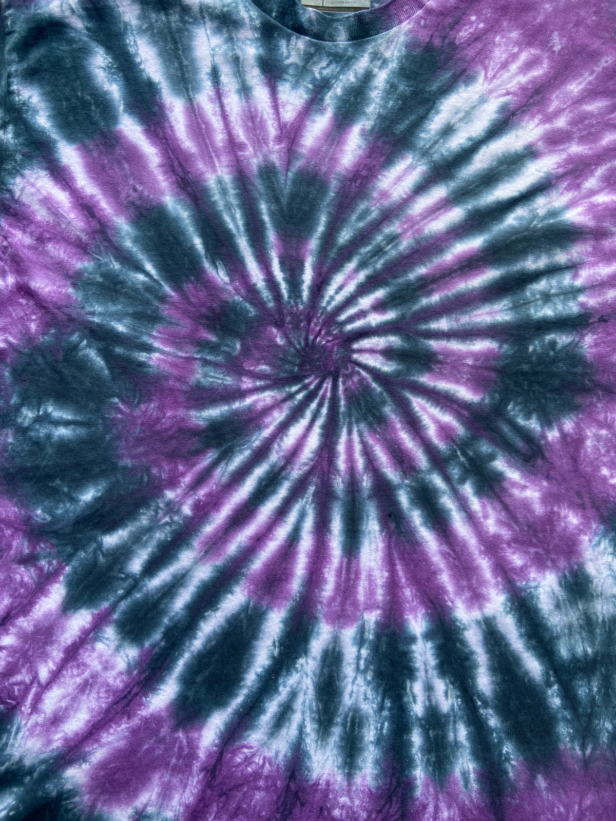 Close-up of the Beetle Spiral tie dye pattern in purple, black and white