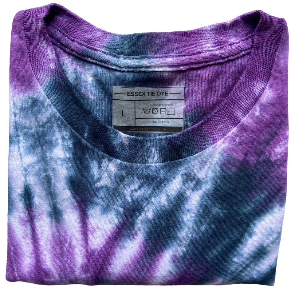 Close-up of the collar and label on the Beetle Spiral tie dye T-shirt in purple, black and white