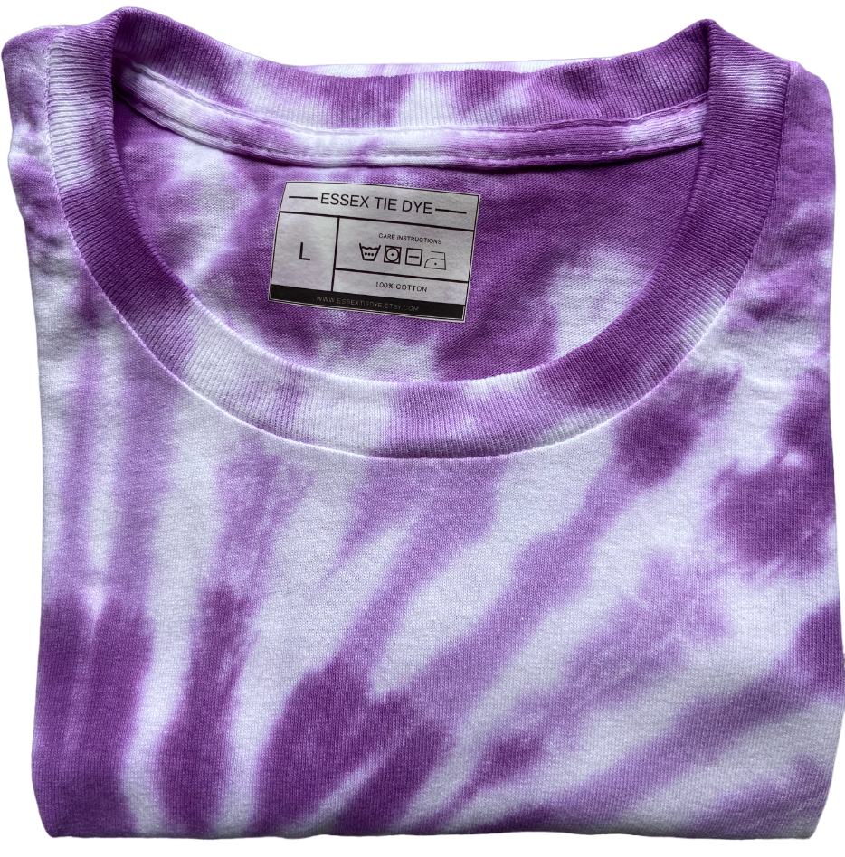 A folded grape and white tie-dye t-shirt with a visible 'ESSEX TIE DYE' brand label inside the collar, set against a plain white background.