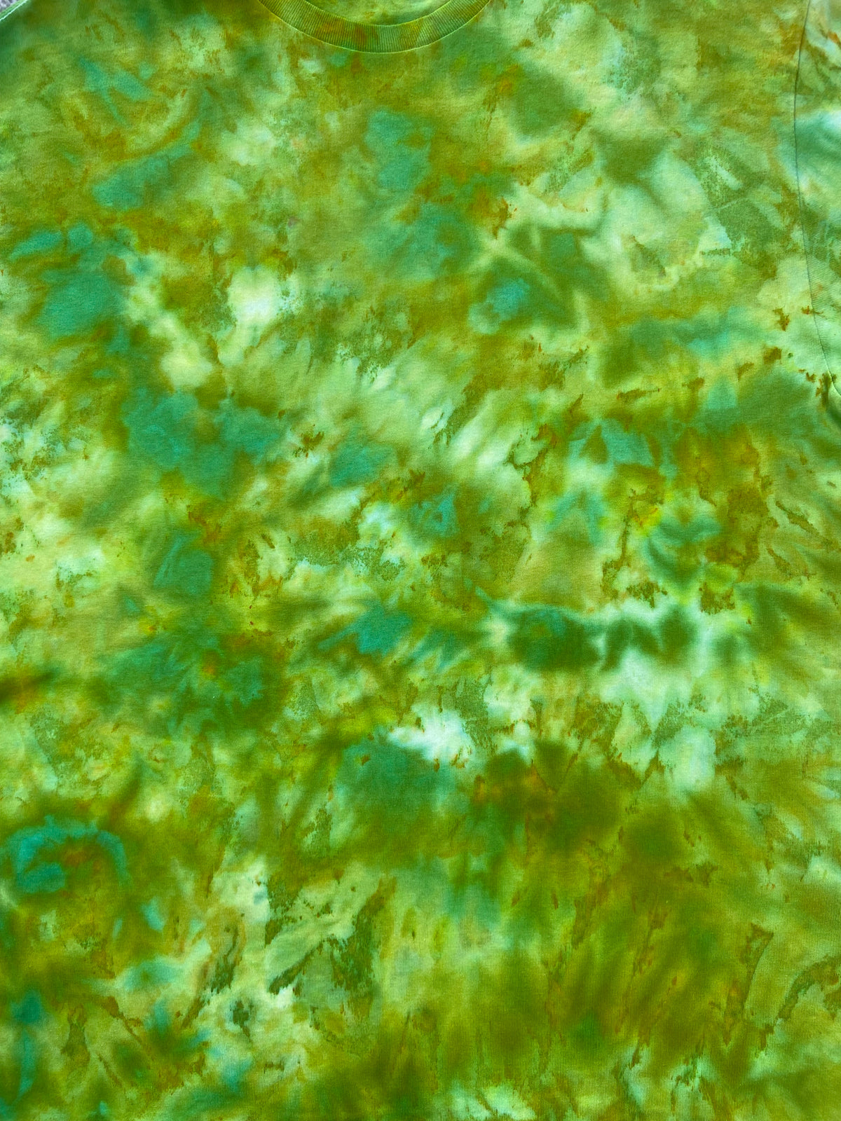 Close-up of the Lime Squeeze Ice tie-dye T-shirt showing blended lime green, aqua blue and white ice-dye detail.