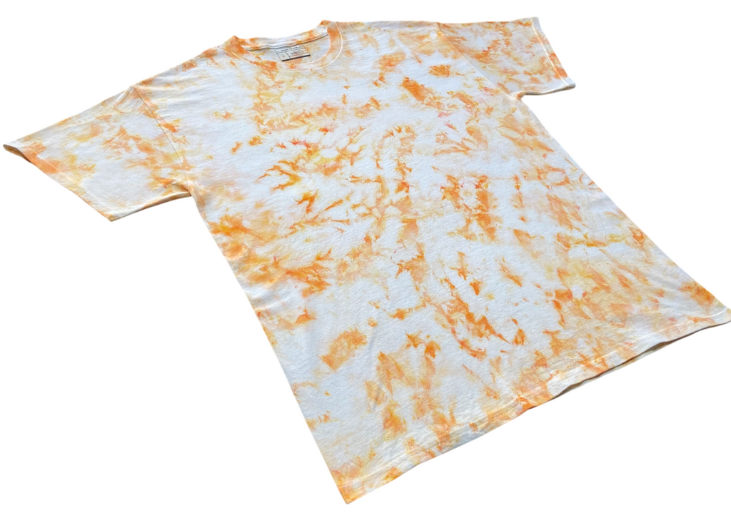 Ivory Ice Scrunch tie dye T-shirt in soft ivory and orange with a subtle hand dyed scrunch pattern on a white background.