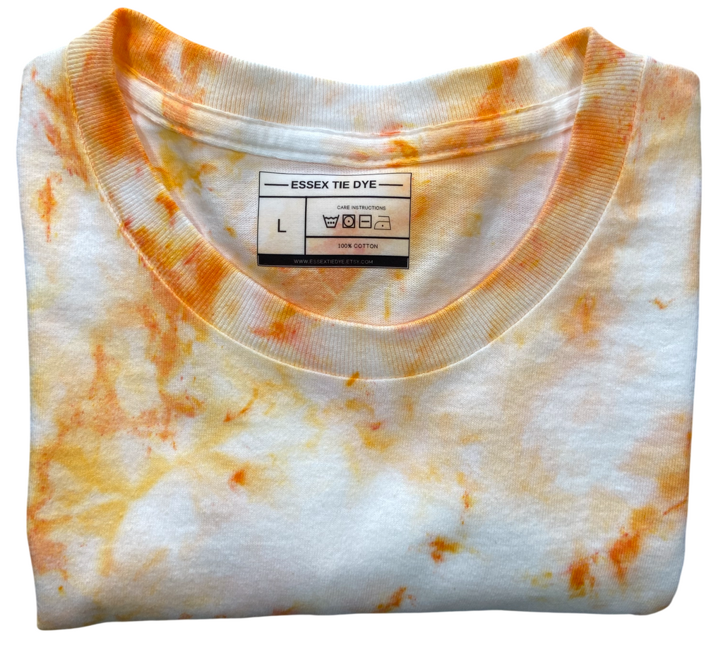 Ivory Ice Scrunch tie dye T-shirt in soft ivory and orange with a subtle hand dyed scrunch pattern on a white background.