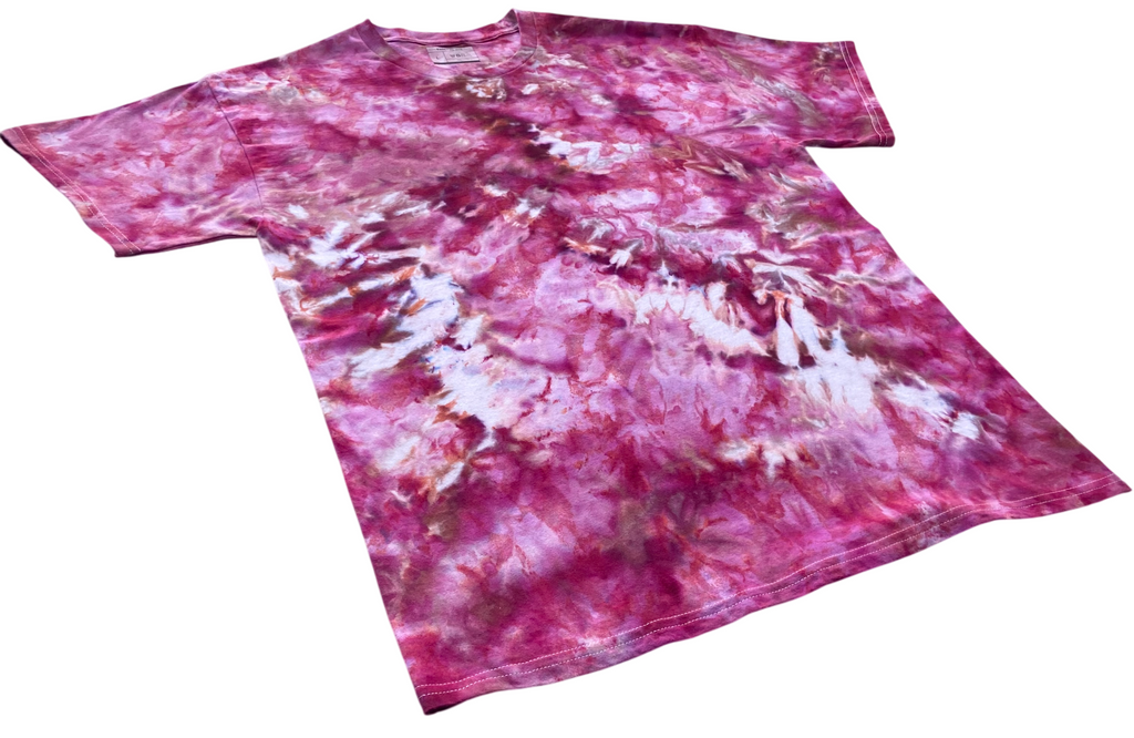 A short-sleeve crewneck t-shirt featuring a vibrant pink and purple tie-dye pattern with white marbled accents, displayed on a clean white background.