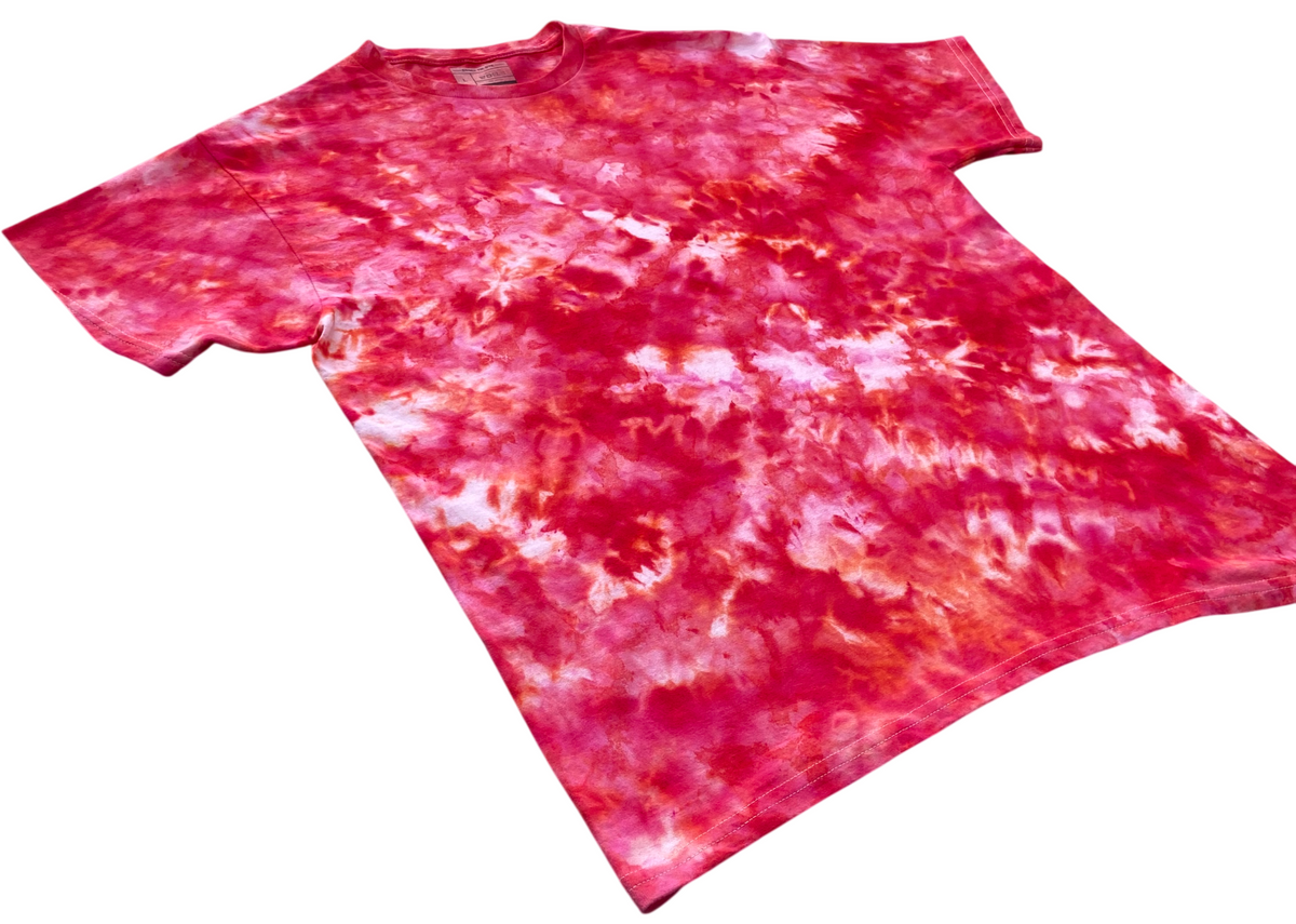 Angled view of the Watermelon Ice Scrunch tie-dye T-shirt featuring watermelon pink, deep pink, red and soft white marbled patterns.