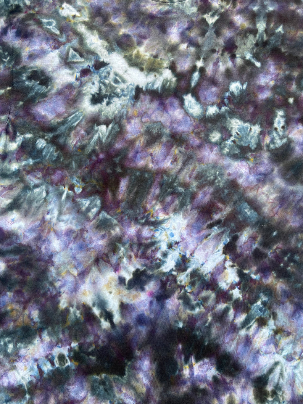 Close up of Tie-dye t-shirt with a multicolor pattern of greys and purples