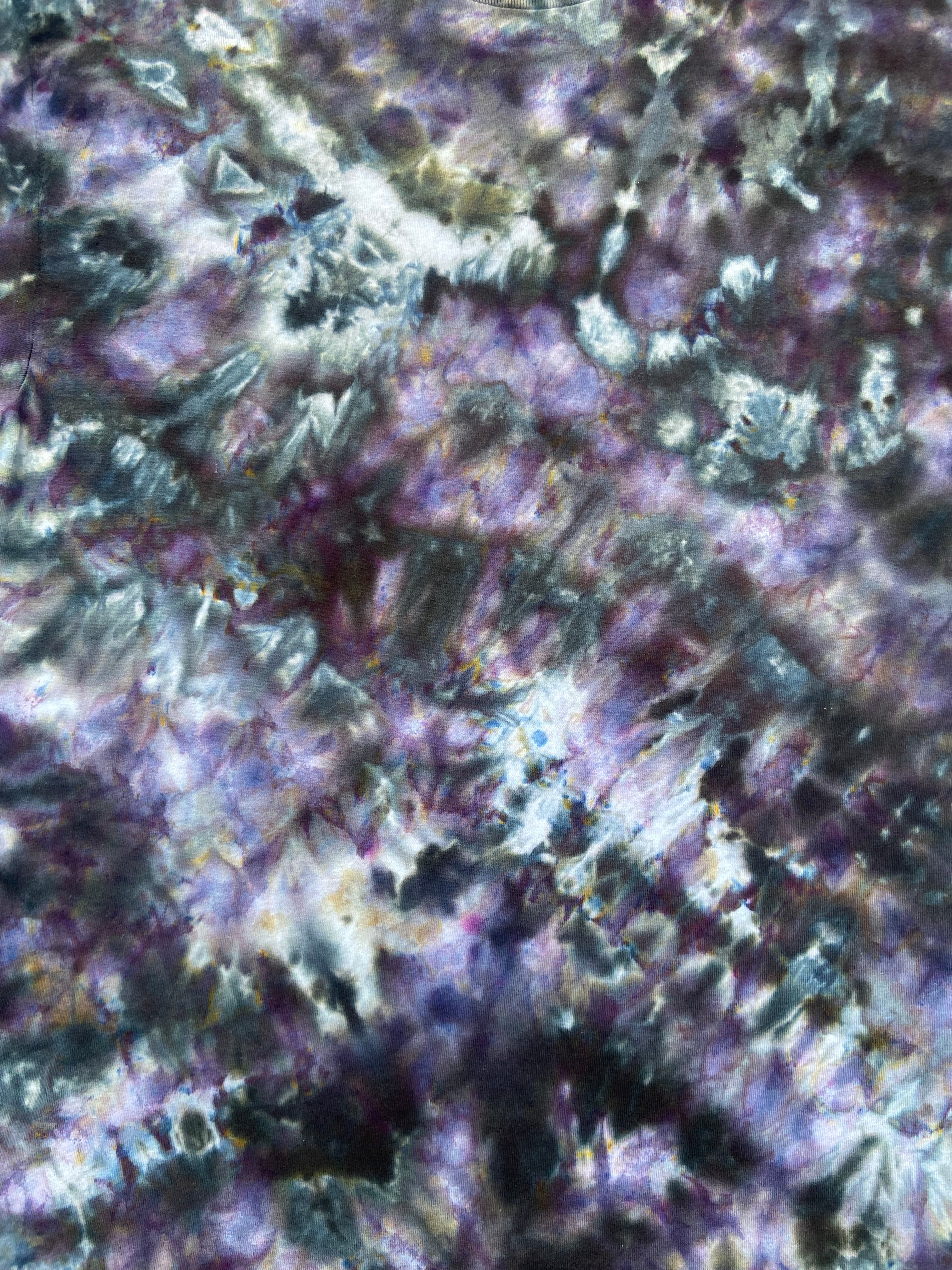 Close up of Tie-dye t-shirt with a multicolor pattern of greys and purples