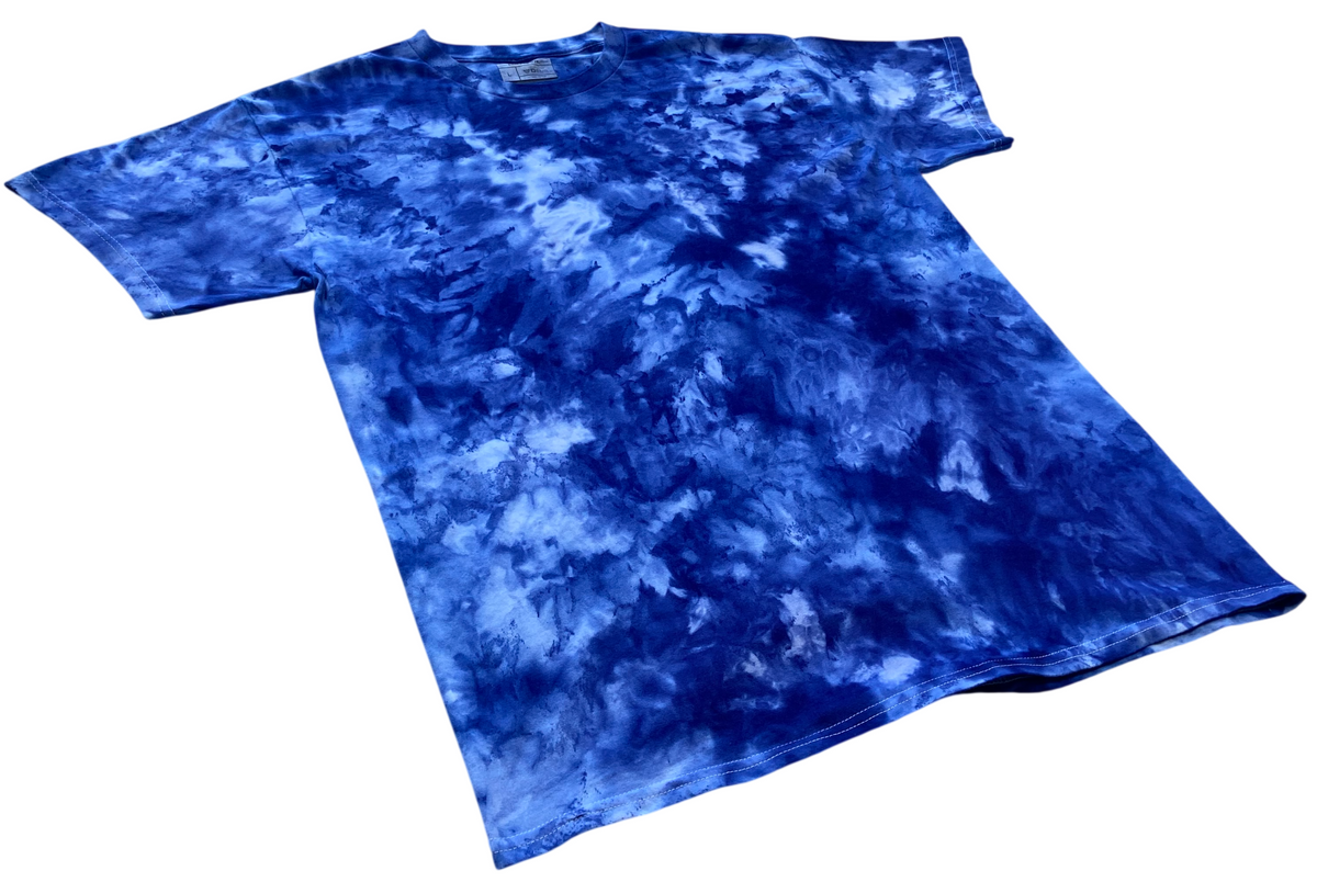 Houdini Blue Ice Scrunch tie-dye T-shirt shown at an angle, featuring deep blue and white ice-dyed patterns.