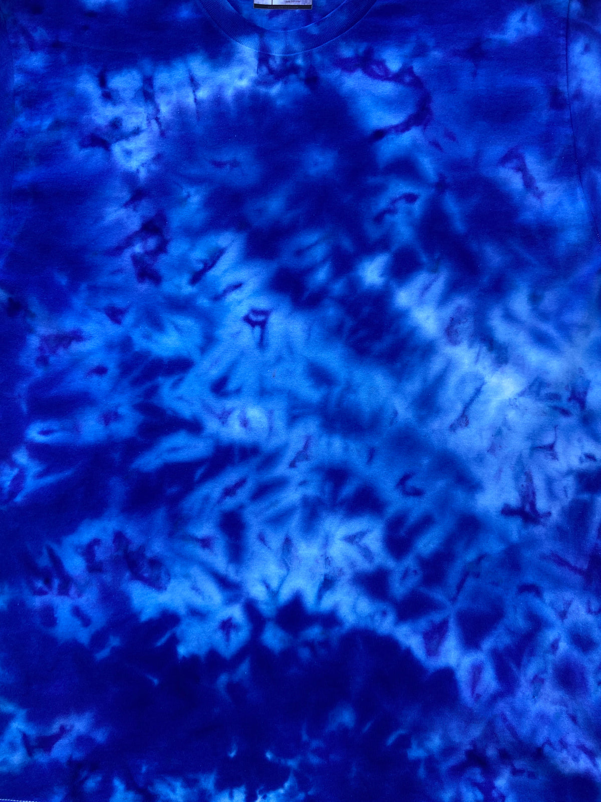 Close-up of Stratosphere Ice Scrunch tie dye fabric in vivid cobalt blue, electric blue and lighter icy blue tones, individually hand dyed in the UK.