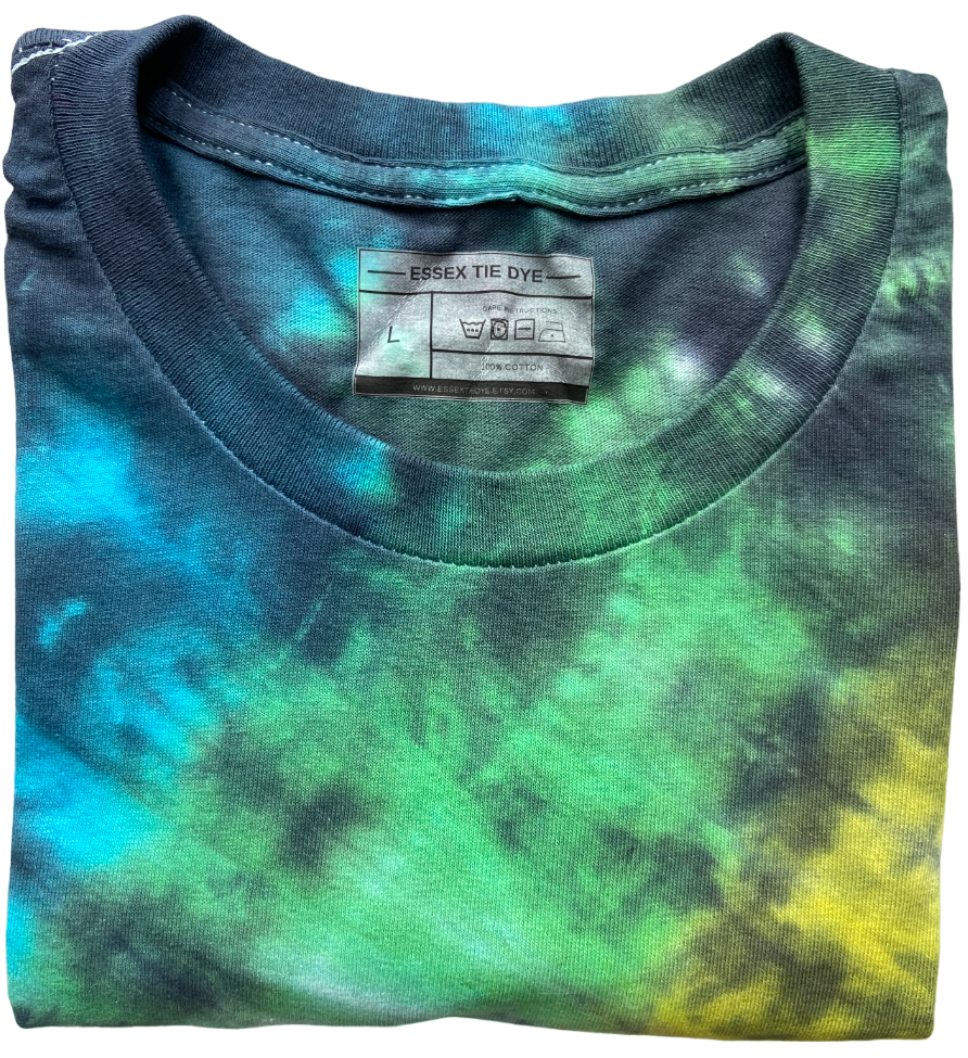 Folded tie-dye shirt with a visible label on a white background