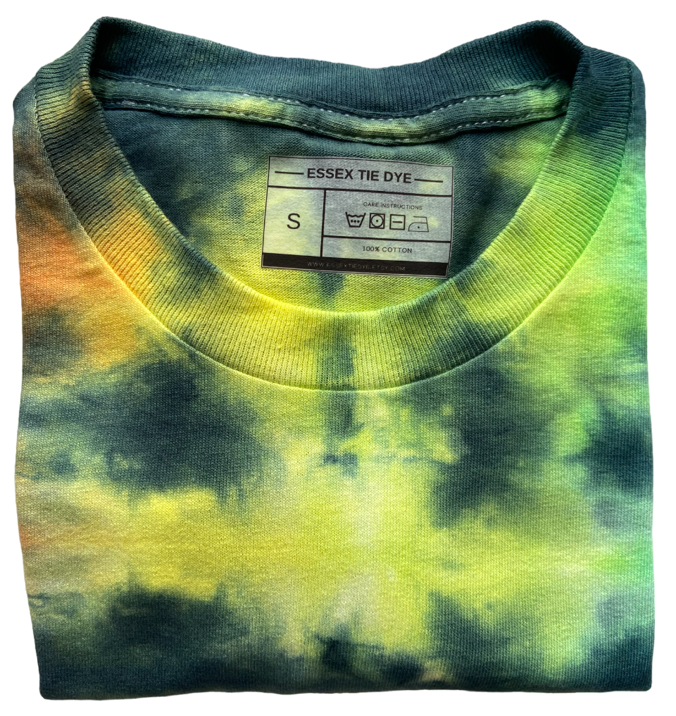 A folded crewneck t-shirt featuring a vibrant green, yellow, and orange tie-dye pattern. The inside collar shows a brand label for 'ESSEX TIE DYE' indicating size S.