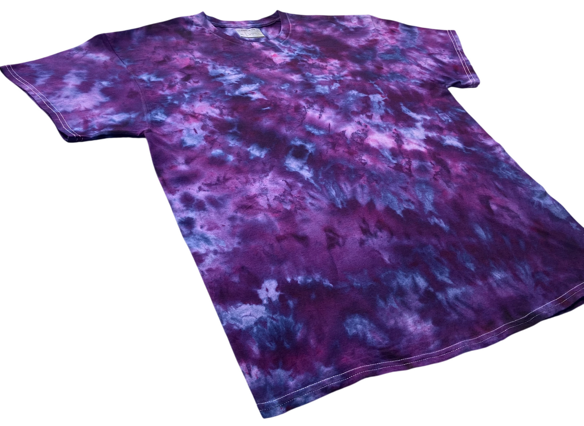 Imperial Purple Ice Scrunch tie dye T-shirt shown at an angle, featuring deep purple, violet, magenta and blue hand-dyed patterns.