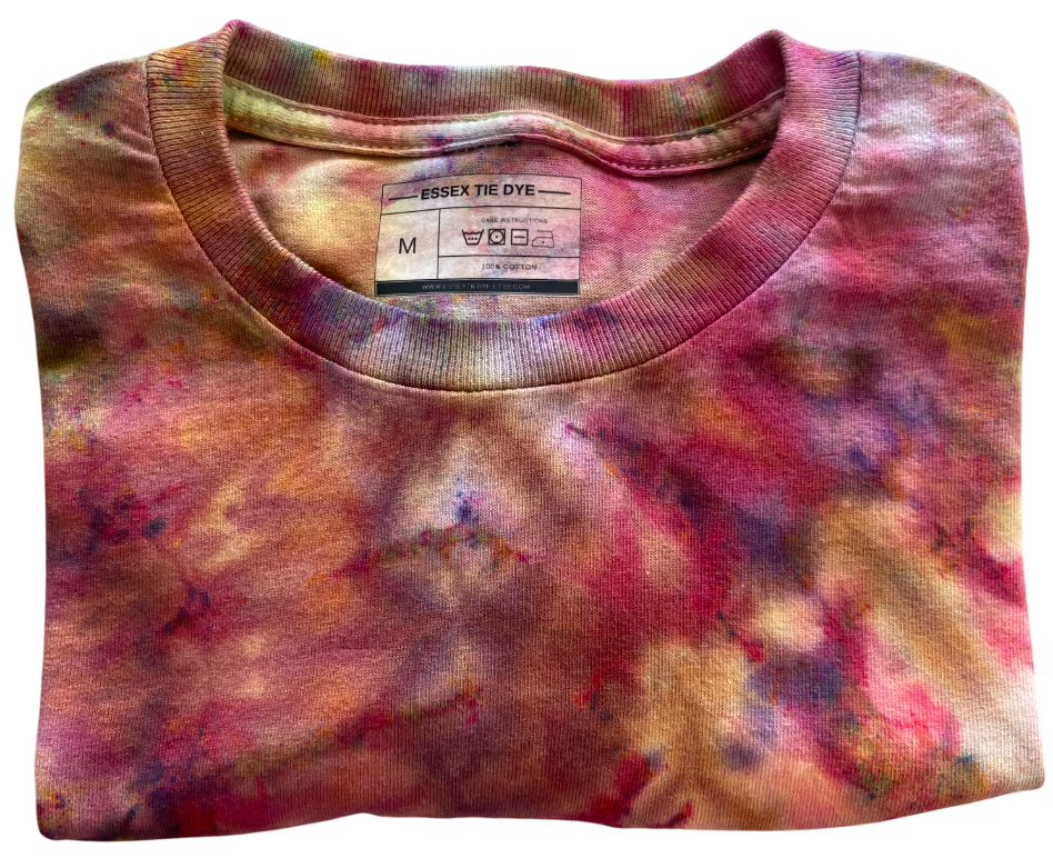 Folded tie-dye shirt with a visible label on a white background